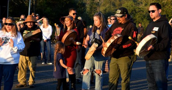 Snoqualmie Tribal members play a song as the boat departs to release the Kokanee at Lake Sammamish State Park. Photo by Conor Wilson/Valley Record