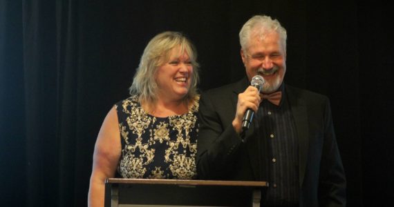 Clark and Karrie Roberts, behind Valley-based nonprofit Ultimate Vision, speak at the opening of the Seeing & Sharing the Heart of Kindness Gala on Oct. 16 at the Hilton Garden Inn in Issaquah. Photo by Conor Wilson/Valley Record