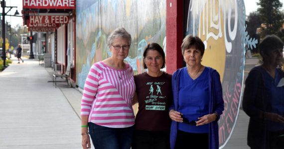 Jules Hughes, center, stands with Jackie Norris (l) and Kris Kirby outside Miller's in Carnation. Photo by Conor Wilson/Valley Record