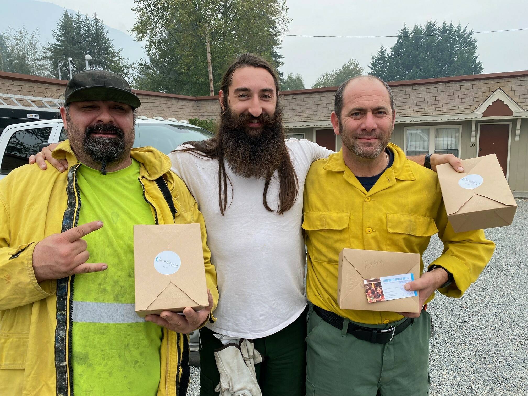 Photo courtesys of Tarah Smigun 
Three firefighters from Methow Valley supporting wildfire fighting efforts outside Snoqualmie receive lunch from Snoqualmie Casino employees. Below, Larell Ezell, of the Snoqualmie Casino, spearheads lunch assembly for firefighters.