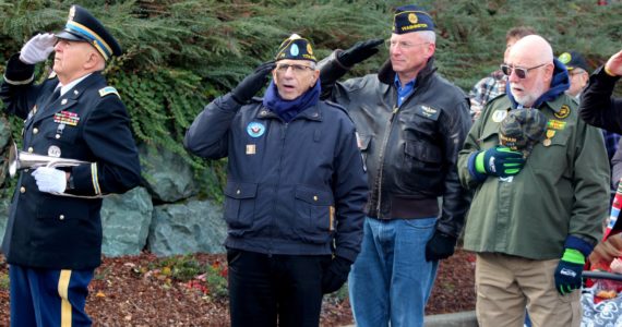 Veterans salute the flag at the Snoqualmie Casino  on Nov. 11 during a singing of the national anthem. All photos Conor Wilson/Valley Record.