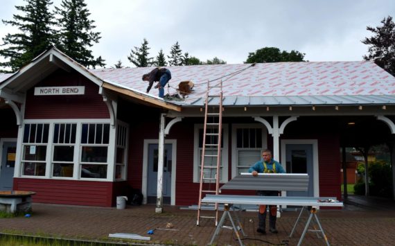 Workers fix the roof at North Bend Train Depot in Taylor Park on June 17. Photo by Conor Wilson/Valley Record