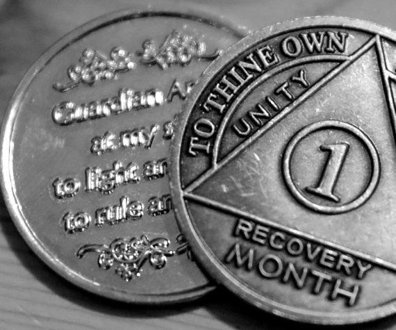 One person’s month recovery coins after battling a fentanyl addiction. (Kevin Clark / The Herald)