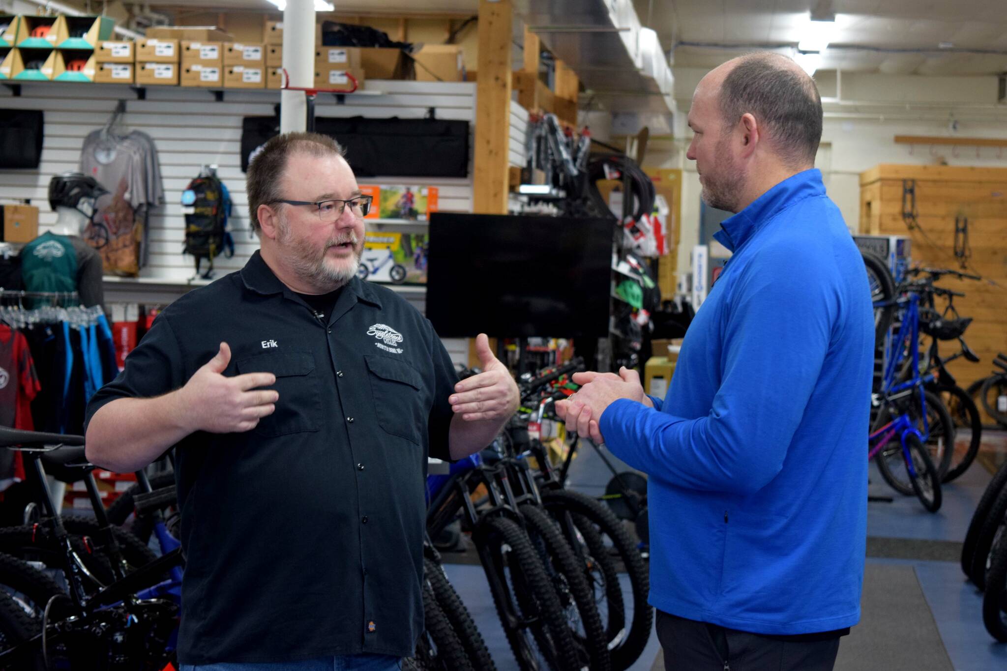 Brian Davis (R) speaks to Erik Alston, owner of Singletrack Cycles.