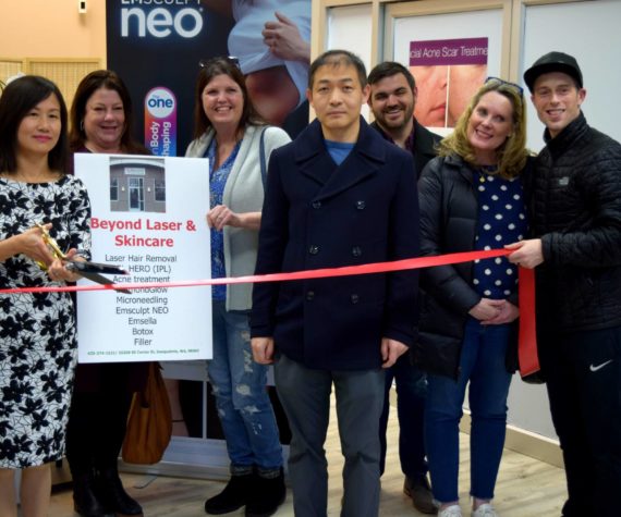 <p>Biwei Dong (left), owner of Beyond Laser & Skin Care, and her husband are joined by members of the SnoValley Chamber of Commerce, Downtown Merchants Association and City of Snoqualmie in celebrating the opening and one-year anniversary of her business on Jan. 19. Photo Conor Wilson/Valley Record.</p>