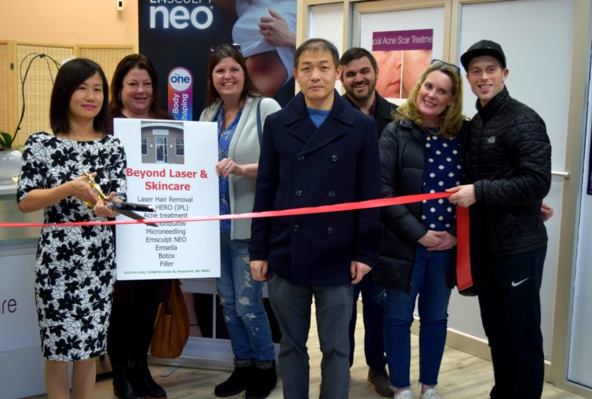 <p>Biwei Dong (left), owner of Beyond Laser & Skin Care, and her husband are joined by members of the SnoValley Chamber of Commerce, Downtown Merchants Association and City of Snoqualmie in celebrating the opening and one-year anniversary of her business on Jan. 19. Photo Conor Wilson/Valley Record.</p>