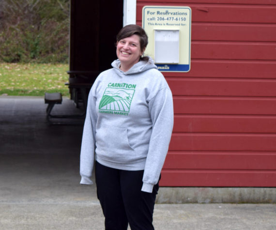 Conor Wilson / Valley Record 
Lindsay Gilliam, executive director of the Carnation Farmers Market, poses in front of the Red Barn at King County’s Tolt-McDonald Park, the market’s new home.