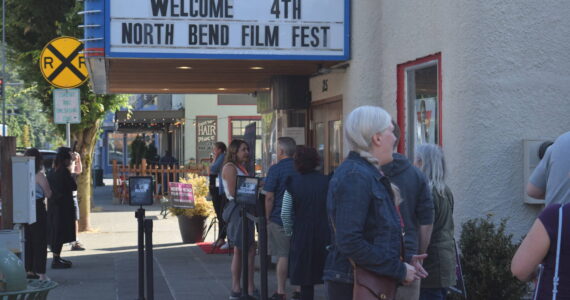 Patrons wait outside the North Bend Theater on the opening night of North Bend Film Fest on July 15, 2021. File photo by Conor Wilson/Valley Record