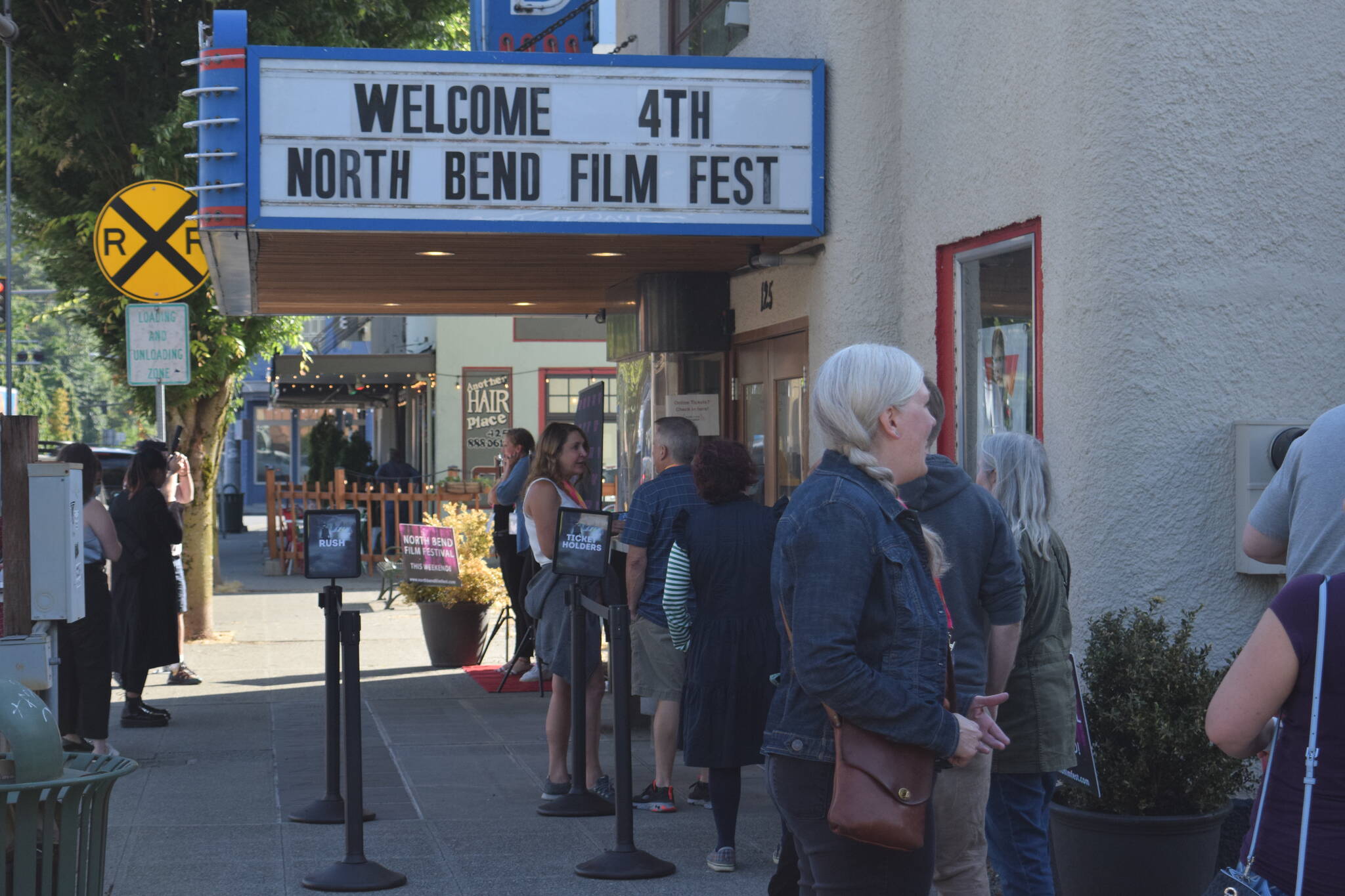 Patrons wait outside the North Bend Theater on the opening night of North Bend Film Fest on July 15, 2021. File photo by Conor Wilson/Valley Record