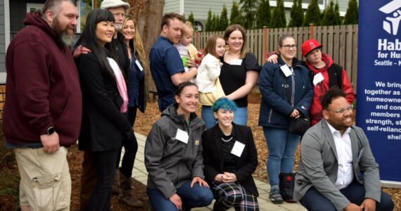 Some of the new homeowners at Tyler Town in North Bend pose for a group photo with Habitat for Humanity staff. Photos by Conor Wilson/Valley Record