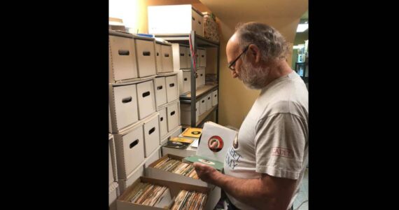 Terry Spring, host of “Saturday Night Oldies” on Valley 104.9, looks through CDs. Courtesy photo.