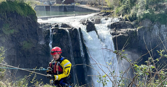 A firefighter starts to rappel to the Snoqualmie River near Snoqualmie Falls as part of a river rescue training session. Courtesy photo, Puget Sound Fire.