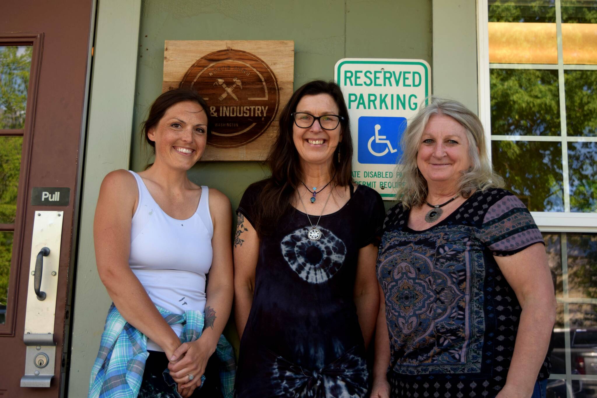 Photos by Conor Wilson/Valley Record.
Members of North Bend Art & Industry pose for a photo outside their new space in downtown North Bend. From left: Sarah Hughes, Ellen Rowan, Deb Landers.