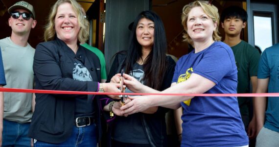 North Bend Trading Co. owners Cheri Buell, Julie Chung, Heather Dean celebrate the opening of their new business with a ribbon cutting ceremony on June 8. Photo by Conor Wilson/Valley Record.