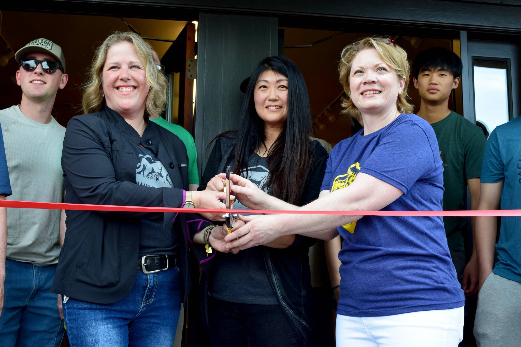 North Bend Trading Co. owners Cheri Buell, Julie Chung, Heather Dean celebrate the opening of their new business with a ribbon cutting ceremony on June 8. Photo by Conor Wilson/Valley Record.
