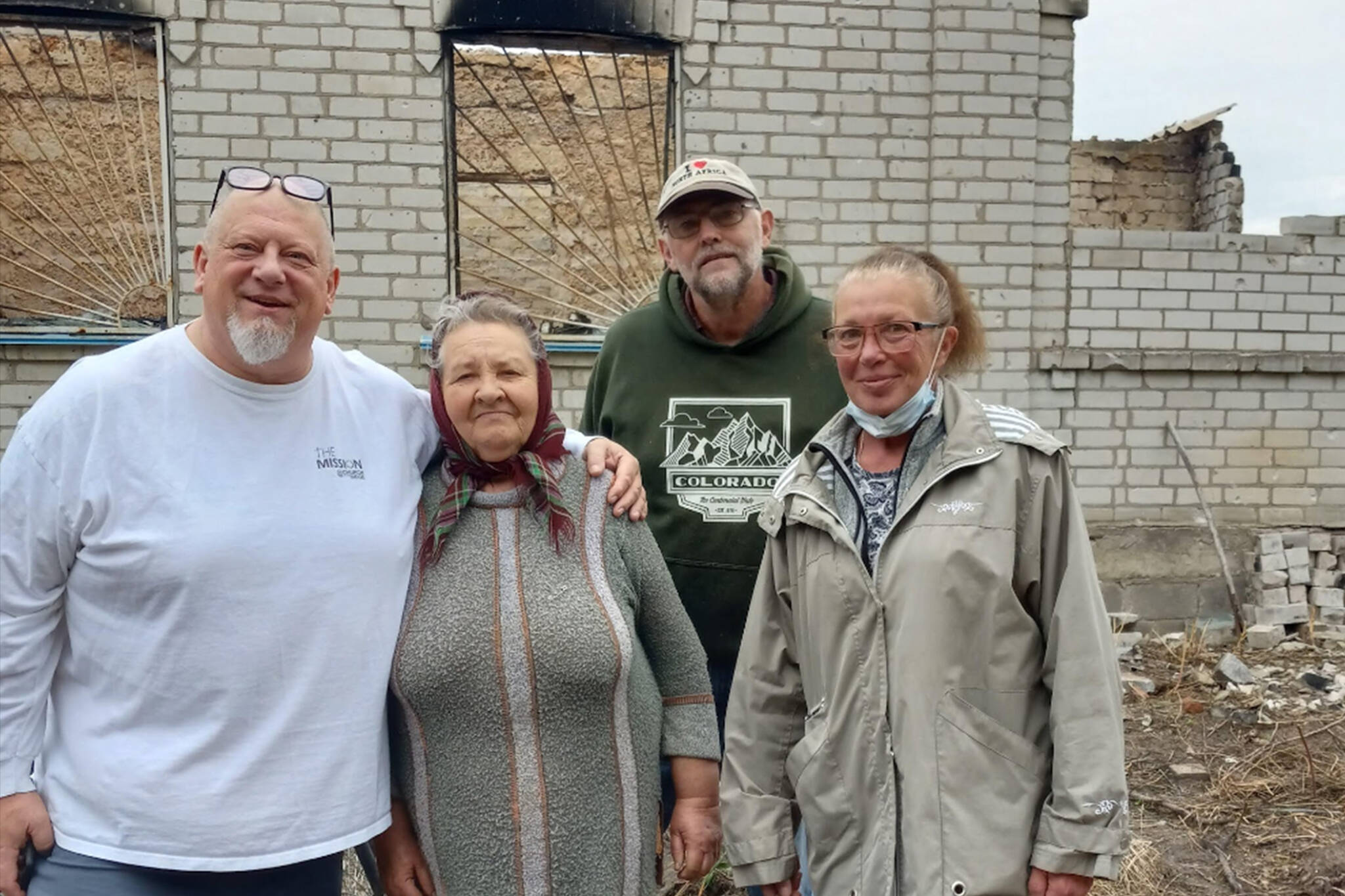(Photo courtesy of Tom Armour) 
ABOVE: Tom Armour, left, poses for a photo in Ukraine. BELOW RIGHT: Volunteers build panel homes.