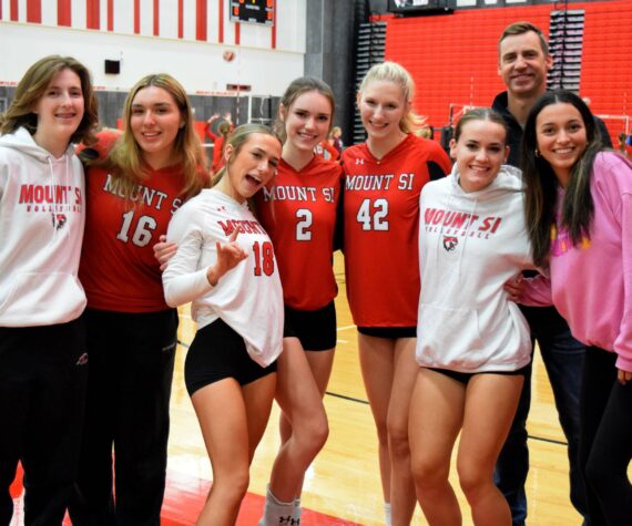 Head Volleyball Coach Brady King Poses for a photo with varsity athletes before a game against Holy Names Academy. Photo Conor Wilson/Valley Record.