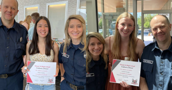 Volunteer Firefighters Josh Demetrescu and Anna Meehan pose for a photo with scholarship award winners Anna Findlay (left) and Lauren Kremer. Photo couresy of the city of Snoqualmie.