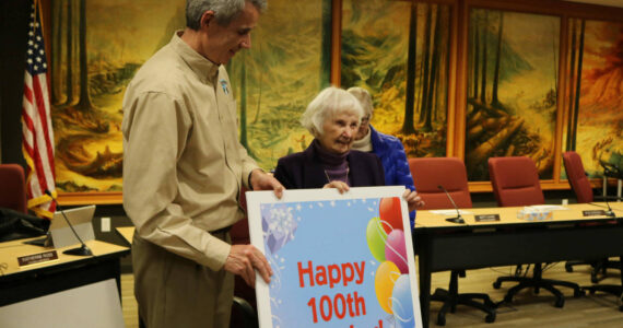 Gloria McNeely stands next former Mayor Matt Larson as she celebrates her 100th birthday at Snoqualmie City Hall. File photo