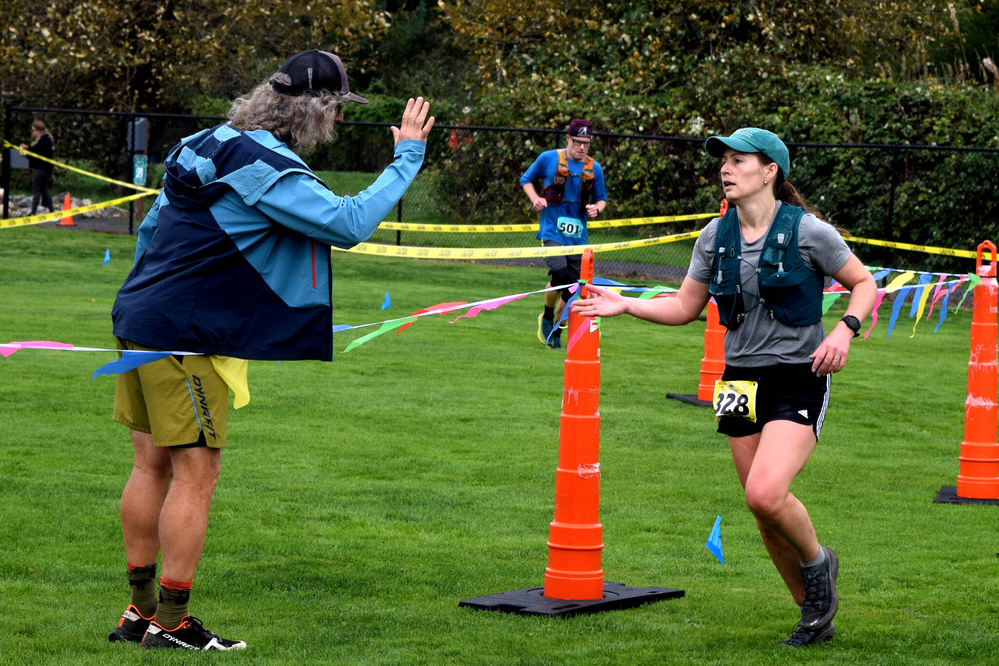 Race organizer Scott Sowle, left, high fives a runner at they finish.