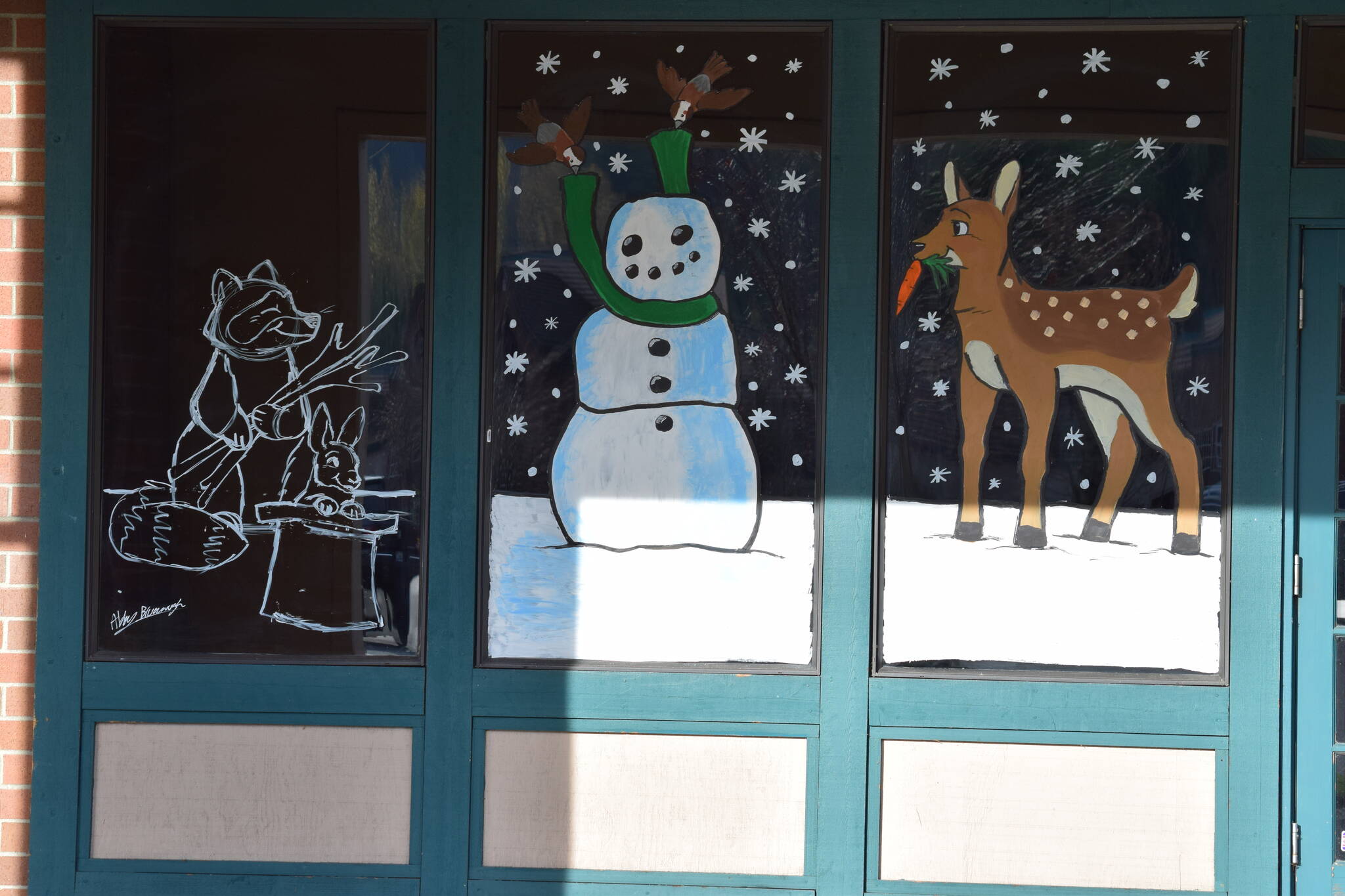 Windows at at North Bend Outlet Mall painted as part of the Holiday Window Painting Contest organized by North Bend Art Industry. Pictured: Artwork by Abby Brunaugh. Photos Conor Wilson/Valley Record.
