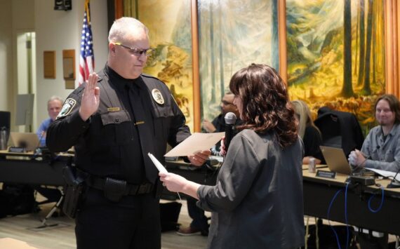 Snoqualmie Police Chief Brian Lynch takes his oath of office alongside city clerk Deana Dean at city hall on Nov. 27. Photo courtesy of the city of Snoqualmie.