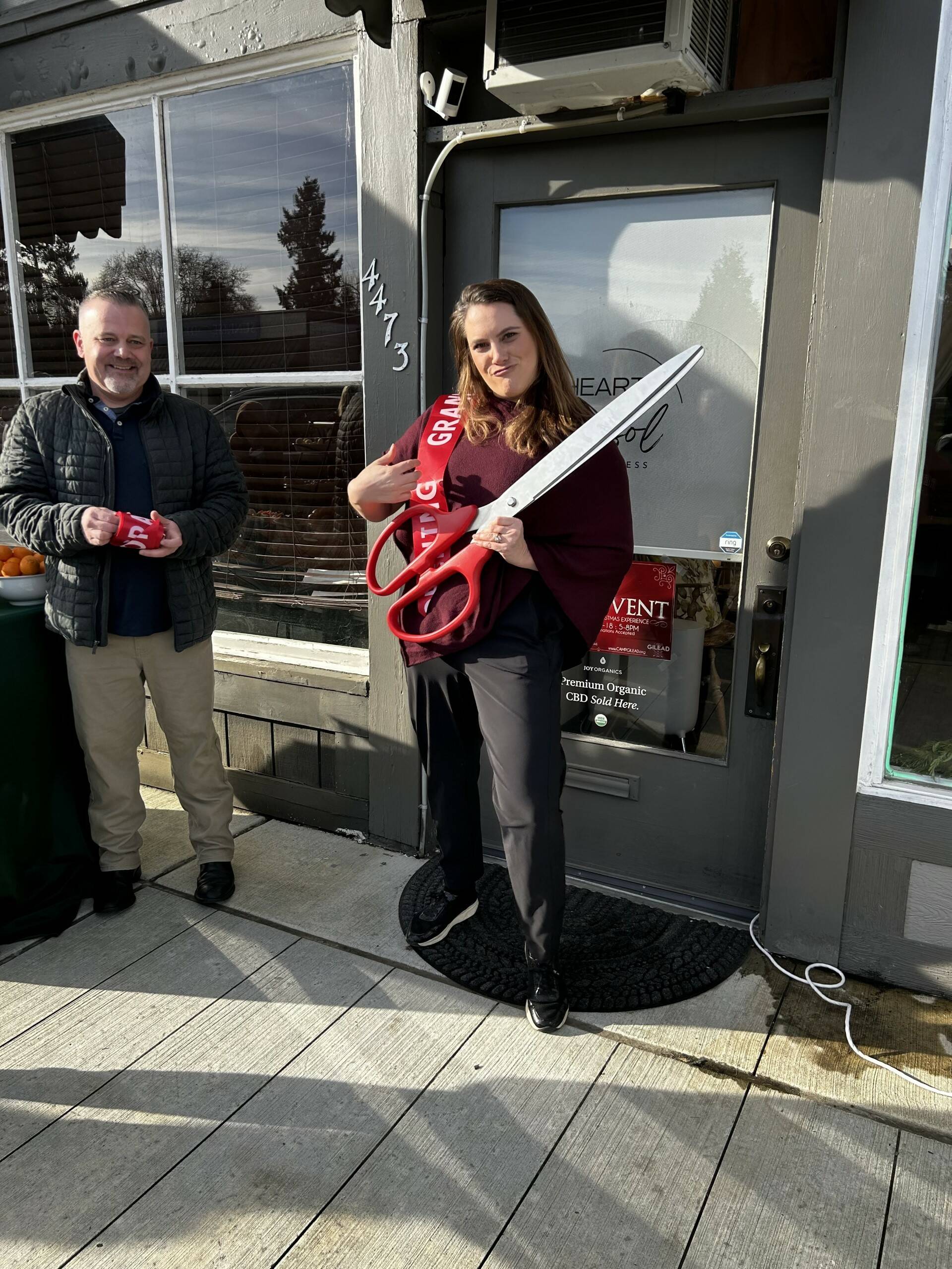 Bethany Lafferty stands next to her shop, located on 4472 Tolt Ave., waiting to cut the ribbon at the grand opening in November. Photo courtesy of Collienne Becker