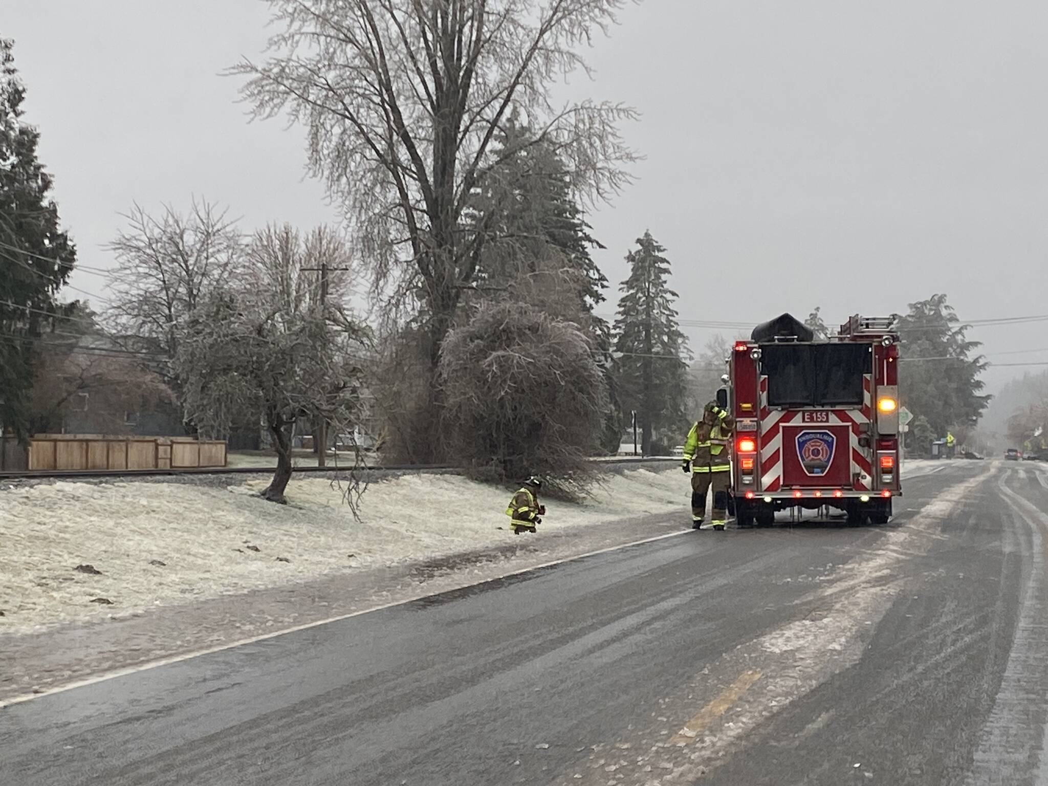 Snoqualmie firefighters respond to snapping trees due to heavy ice. (Photo by William Shaw/Sound Publishing)