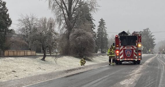 Snoqualmie firefighters respond to snapping trees due to heavy ice. (Photo by William Shaw/Sound Publishing)