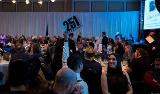 Event attendees participating in the 2023 SnoValley Color Ball live auction. Photo courtesy of Kelly Coughlin