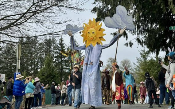 A large, smiling sunflower puppet welcomes a crowd at Depot Park on Saturday, March 30. Photos by Grace Gorenflo/For the Valley Record