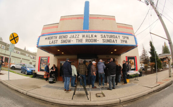 The thirteenth annual North Bend Jazz Walk was held April 27. Nineteen venues throughout downtown North Bend hosted 28 jazz bands with at least 100 total musicians from 5 p.m. to midnight. Learn more at northbendjazzwalk.com. Pictured: Excited guests hide from the rain under the cover of the North Bend Theatre. Photos by Ben Magnus/For the Valley Record