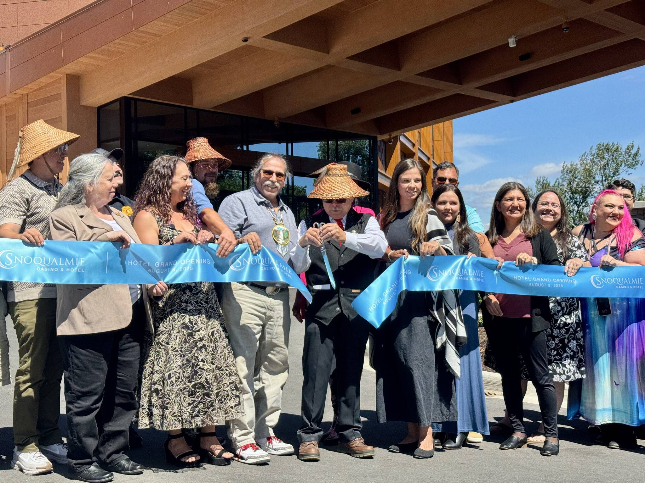 Robert de los Angeles, chairperson of the Snoqualmie Tribal Council, cuts the ribbon at the opening of the Snoqualmie Casino’s hotel, surrounded by tribal members, Aug. 8, 2025. (Grace Gorenflo/Valley Record)