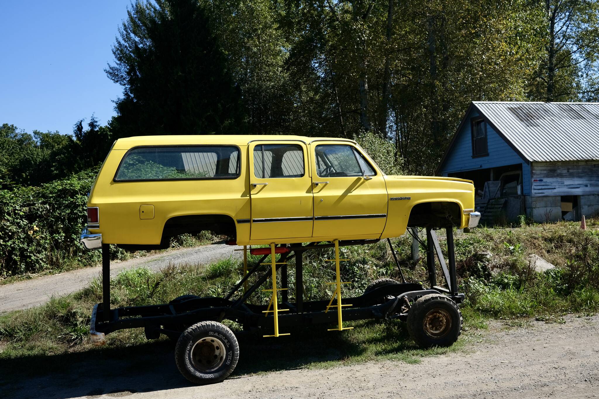 The “Floodmobile,” a Chevrolet Suburban raised to drive through flood waters, sits on Cook Farm, Sept. 16, 2025. This iteration of the Floodmobile is owned by Dan Cook, with an earlier version being owned by his father. Cook says he hasn’t had to use the Floodmobile in many years, but he still brings it out for Duvall parades and events. Grace Gorenflo/Valley Record