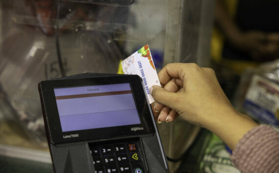 A shopper who receives SNAP benefits slides an EBT card at a checkout counter in a Washington, D.C., grocery store in December 2024. ( U.S. Department of Agriculture)