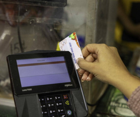 A shopper who receives SNAP benefits slides an EBT card at a checkout counter in a Washington, D.C., grocery store in December 2024. ( U.S. Department of Agriculture)