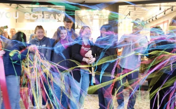 Snoqualmie Ice Cream co-owners Heather Dean and Julie Chung, with their families, cut the ribbon at their grand re-opening, Nov. 19, 2025. (Grace Gorenflo/Valley Record)