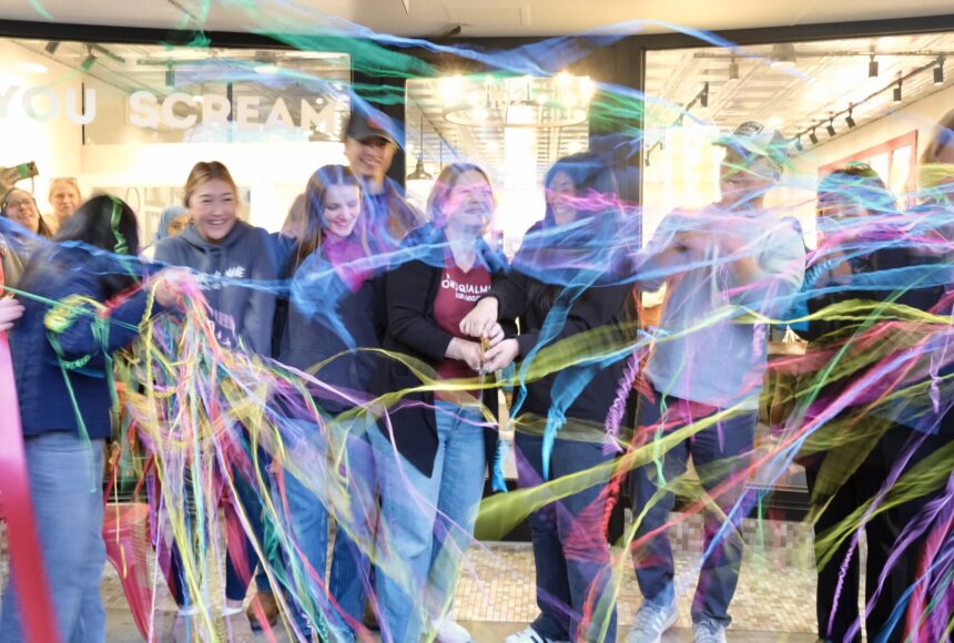 <p>Snoqualmie Ice Cream co-owners Heather Dean and Julie Chung, with their families, cut the ribbon at their grand re-opening, Nov. 19, 2025. (Grace Gorenflo/Valley Record)</p>