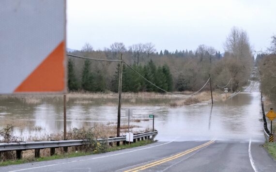 Flood waters flow over NE 124th Street at West Snoqualmie Valley Road NE outside Duvall, Dec. 9, 2025. (Grace Gorenflo/Valley Record)