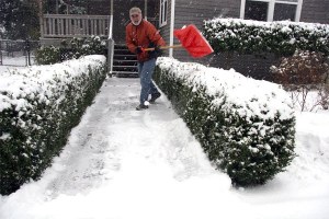 Terry O’Brien of Snoqualmie scoops out his sidewalk after a snowy night. Valley residents should prepare for winter conditions by stocking up on supplies for the car and home.