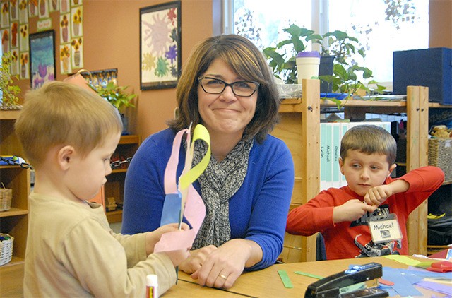 Encompass Executive Director Nela Cumming visits with some preschool students.