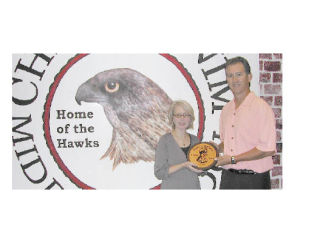 Barb Wozdin and Chief Kanim Middle School Principal Kirk Dunckel display Chief Kanim’s latest award from the Leukemia and Lymphoma Society’s School and Youth Programs for Pennies for Patients. This year