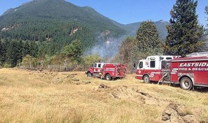 Six fire agencies responded to the brush fire in North Bend Sunday afternoon. The fire was contained by 4 p.m. No cause has been reported yet.
