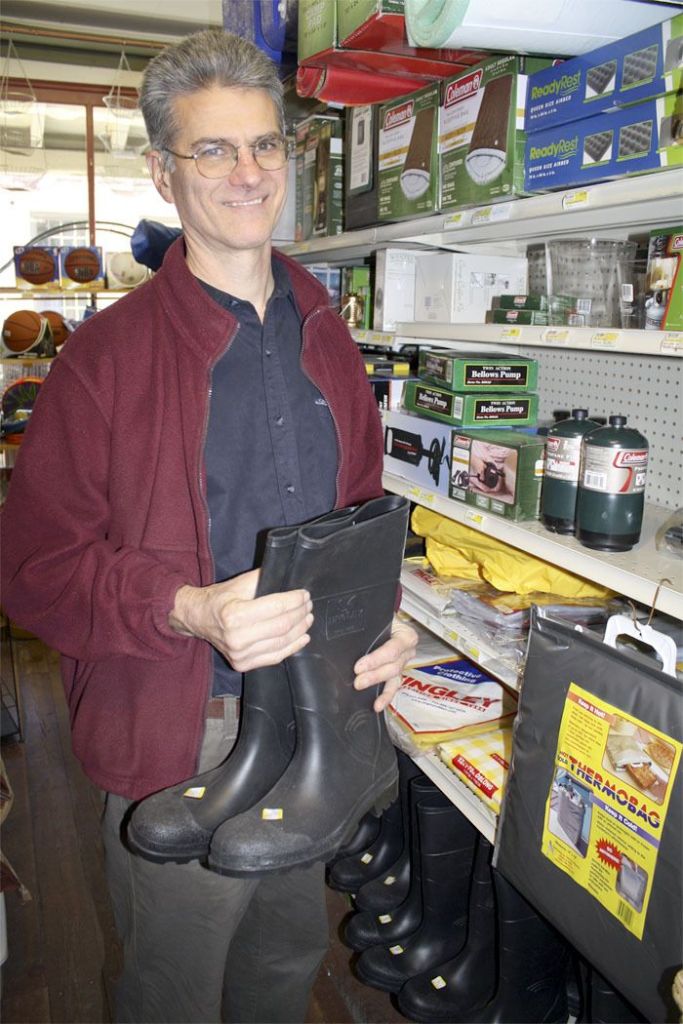 Carmichael’s True Value owner Brian Woolsey breaks out the rain galoshes