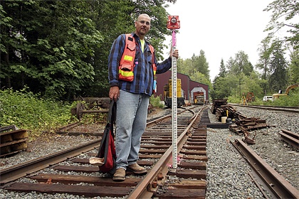 Jay McCombs of Issaquah-based Eastside Consultants helps survey the site of the Northwest Railway Museum’s proposed Train Shed Exhbiti building at its Stone Quarry Road campus.