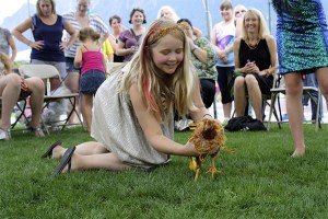 Gwendolyn Kahsen hangs on to a scampering Little Red the hen