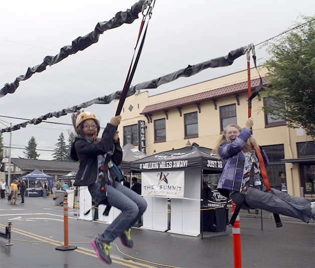Rose Mastberg of Snoqualmie shares a thrill with Gabriel Jiminez of Bothell on the John Day Homes-sponsored zip line in last year’s Adventure Sport Fest. The Festival returns on Saturday