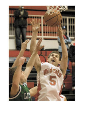 Wildcat Spencer MacEwan rips a rebound down over Liberty defenders in the Dec. 9 home win.