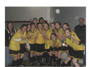 Members of the Roadrunners girls under-14 soccer team hold their trophy following a Tuesday
