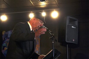 North Bend resident and famed local bandleader Harley Brumbaugh leads a crowd of 80 voices during “I Hear America Singing in 1940